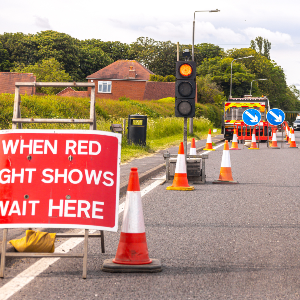 Wait here road works sign